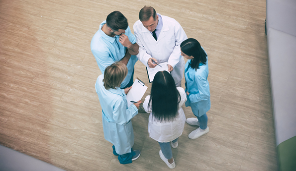 Image of clinicians standing in a circle