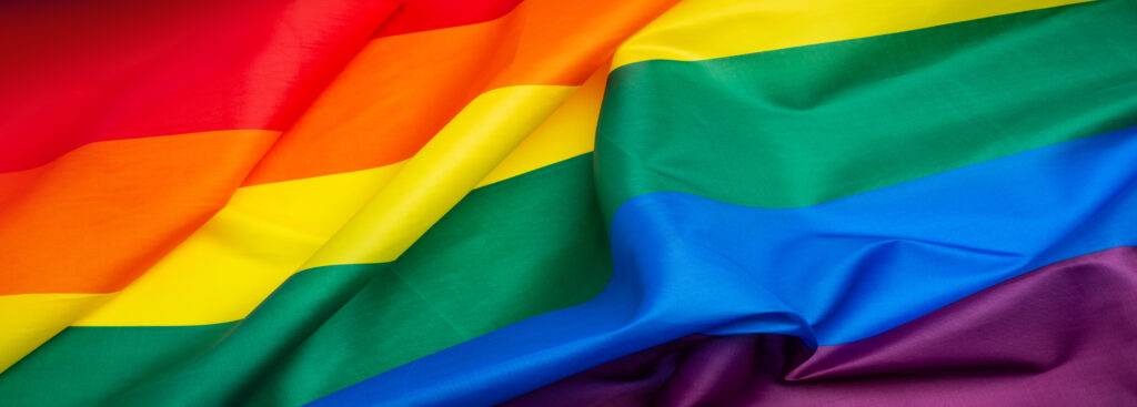 LGBT Pride Month 2024 concept with rainbow flag. LGBTQIA Pride colorful wave background